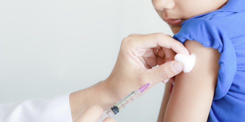 Boy and vaccine syringe